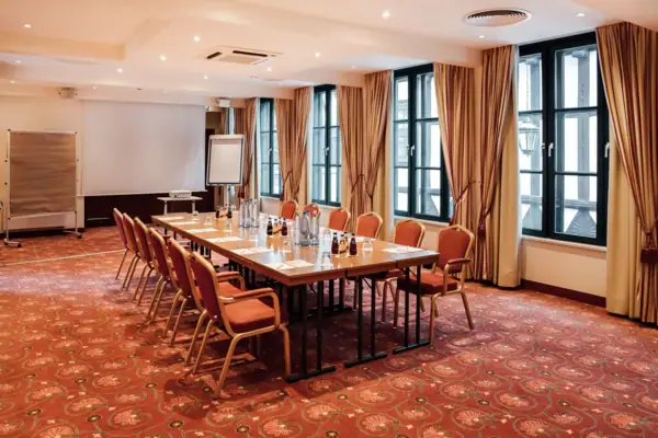 Ein Zimmer mit einem Tisch und Stühlen.