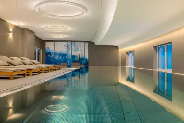 L'area benessere dell'A-ROSA Tegernsee, con piscina coperta e lettini.