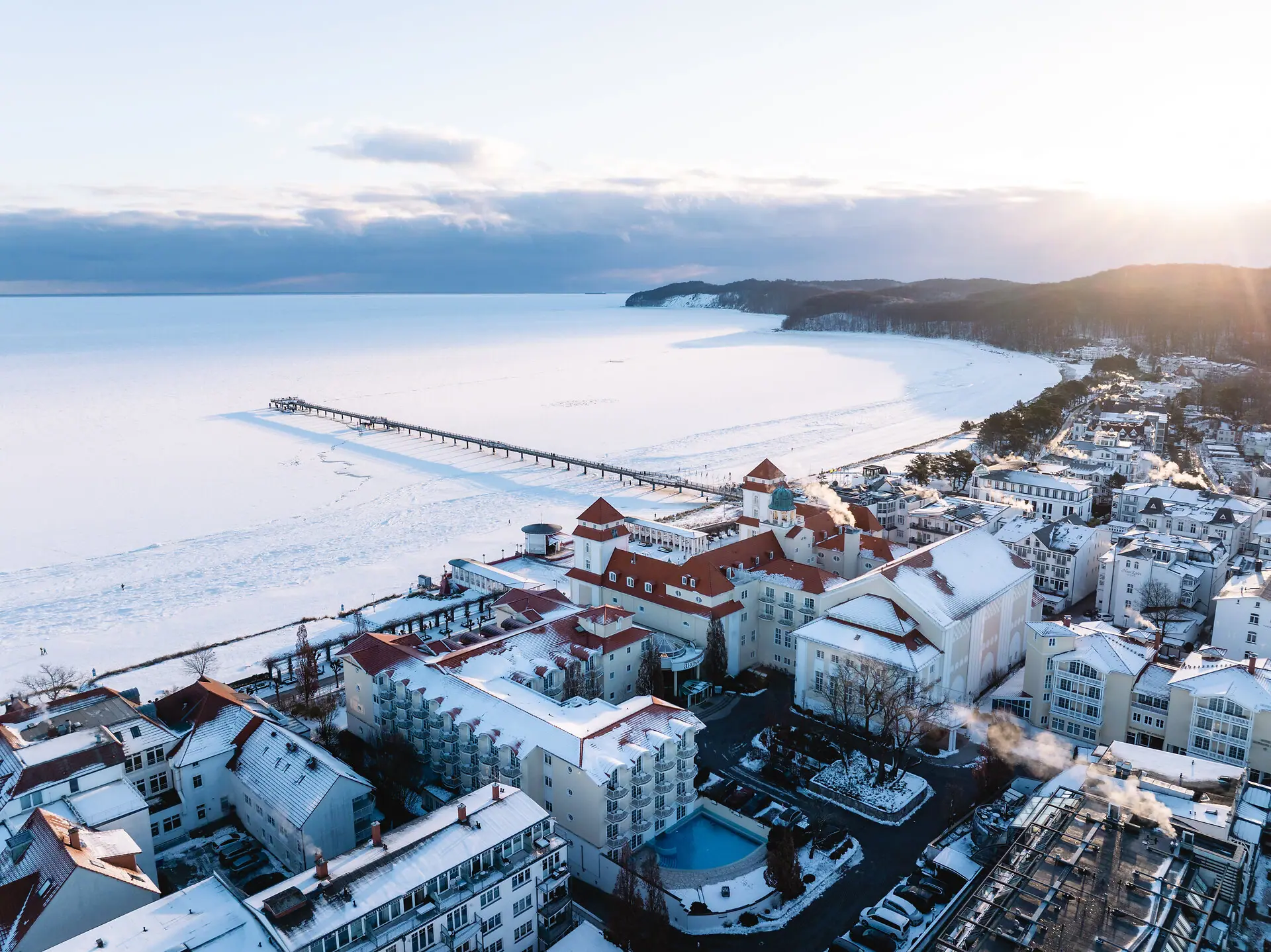 Binz in inverno Una città ricoperta di neve, situata in riva a un corso d'acqua.