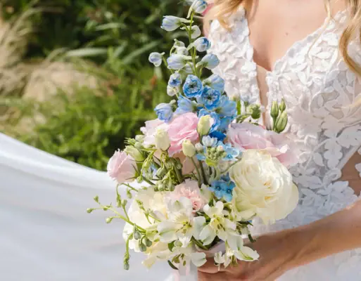 Bouquet da sposa Una donna in abito da sposa bianco tiene in mano un mazzo di fiori.