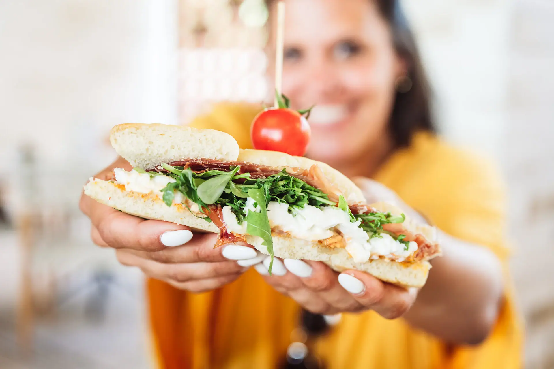 Donna che tiene un sandwich.