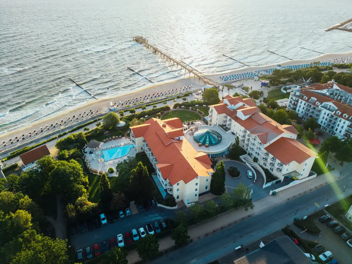 Vista aerea di un resort con piscina e molo.