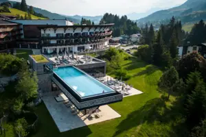 Piscina all'aperto di un hotel con vista sugli alberi e sul cielo.
