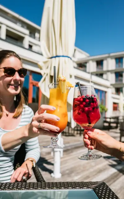 Gruppo di donne all'aperto che tengono dei drink.